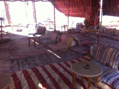 a living room with a long couch and tables at Holiday Sharm in Sharm El Sheikh