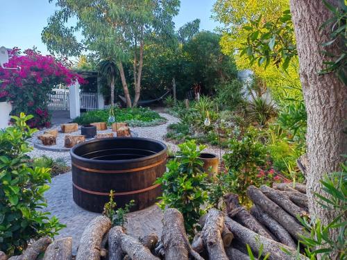 a garden with a barrel and a tree at Fishermansrest in Velddrif
