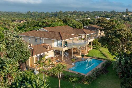 an aerial view of a house with a swimming pool at Albatross Guesthouse in Southbroom