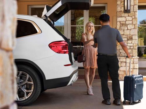 a man and a woman getting into a white car at Hyatt Regency Sonoma Wine Country in Santa Rosa
