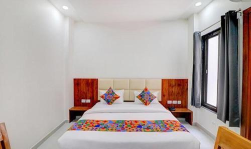 a bedroom with a large bed in a room at FabExpress Pravi Inn in Lucknow