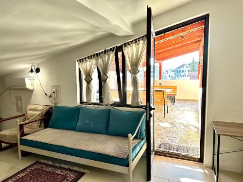 a room with a bed and a glass door to a patio at Apartments Simovic in Tivat
