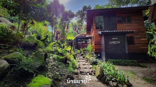 a garden with a path leading to a house at MayamYay Privacy Homestay @Mea Nea Chiang Dao in Chiang Dao