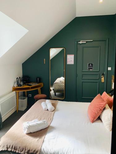 a bedroom with a large bed with a mirror at Le Château des Forges in Angers