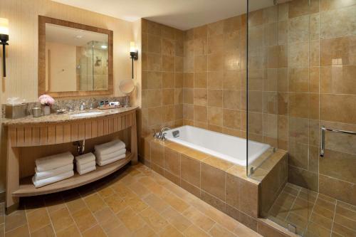 a bathroom with a tub and a sink and a shower at Suncadia Resort in Cle Elum