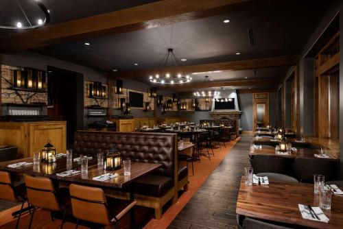 a restaurant with tables and chairs and a bar at Suncadia Resort in Cle Elum