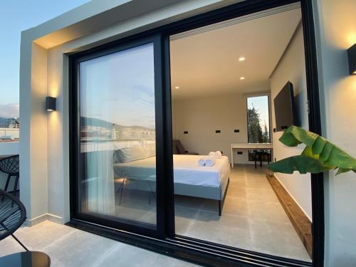 a room with a bed and a large window at Hyperion Penthouse in Patra