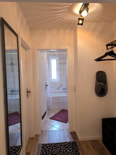 a bathroom with a walk in shower and a mirror at Fewo BUDDY, 2 große Zimmer mit Balkon in Todtmoos