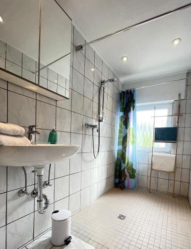 a bathroom with a sink and a shower at Gästehaus An der Berbke in Arnsberg