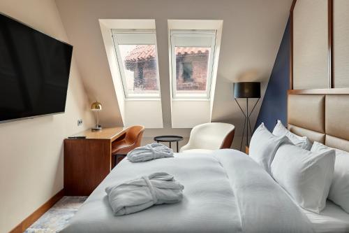 a hotel room with a bed and a flat screen tv at Hilton Gdansk in Gdańsk