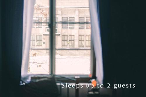 a window with a view of a building at 石と鉄-House of STONE and IRON in Otaru