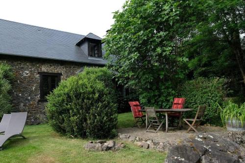 3 chaises et une table dans une cour dans l'établissement Authentic French house with great view 4 bedrooms and a lot of land, à Troche