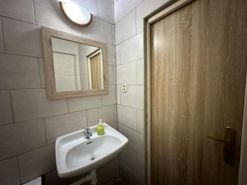 a bathroom with a sink and a mirror at Penzión Tina in Prešov