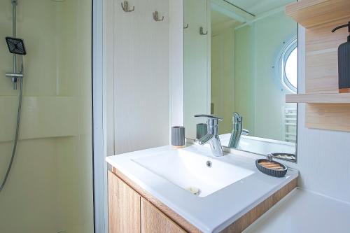 a bathroom with a sink and a shower at New - Mobil home tout équipé in Saint-Jean-de-Monts