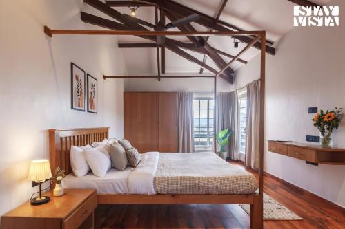 a bedroom with a canopy bed in a room at StayVista's Rustique Radiance - Hillside Retreat with Outdoor Pool & South Indian Architecture in Khopoli