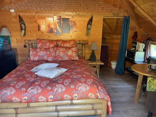 a bedroom with a bed in a log cabin at Aux murmures de la nature in Honfleur