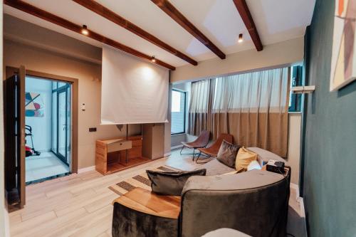 a living room with a couch and a table at Fortunella Villas in Finike