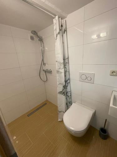 uma casa de banho com um WC e um chuveiro em gemütliches und Schönes Zimmer Keller Geschoss K1 em Haßloch