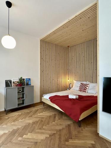 a bedroom with a large bed with a wooden wall at Ateliér U ŘEKY in Ostrava