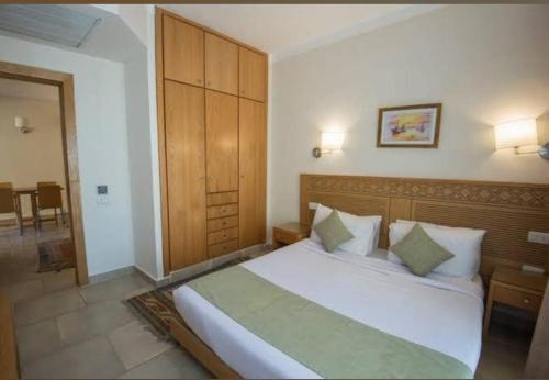 a bedroom with a large white bed in a room at Zahabia Hotel & Beach Resort in Hurghada