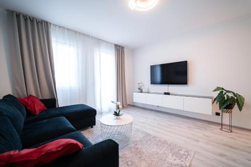 a living room with a couch and a flat screen tv at Luxury Apartment in Peaceful Neighborhood Split in Solin