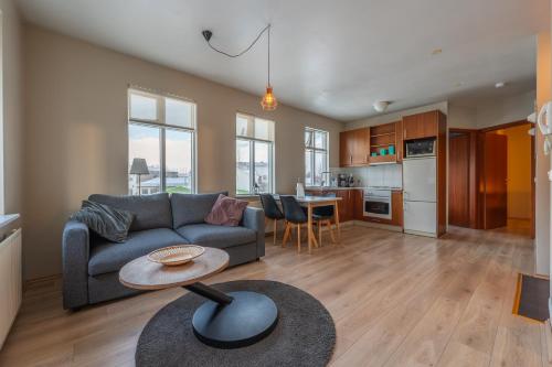 a living room with a couch and a table at Day Dream Strandgata 11 in Akureyri
