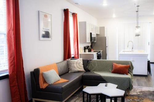 a living room with a couch and a kitchen at Stunning 4-BR Houses with On-Site Pool in Bloomington