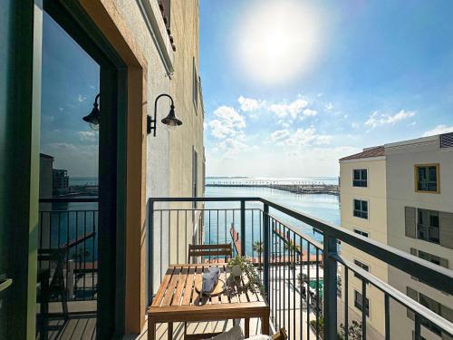 a balcony with a bench and a view of the water at HiGuests - Coastal Chic Luxurious Retreat at Port de la Mer in Dubai