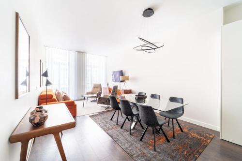 a white living room with a table and chairs at T1 Urban Charm Central City Escape in Braga