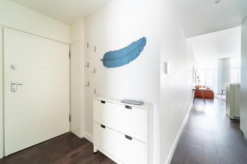 a white room with a blue shoe on the wall at T1 Urban Charm Central City Escape in Braga