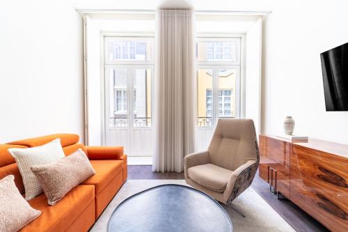 a living room with a couch and a chair at T1 Urban Charm Central City Escape in Braga