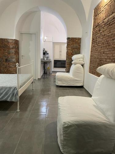 a living room with two beds and a table at Catania Centro Storico in Catania