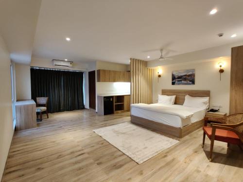 a bedroom with a bed and a desk and a couch at Swanotel Gachibowli in Gachibowli