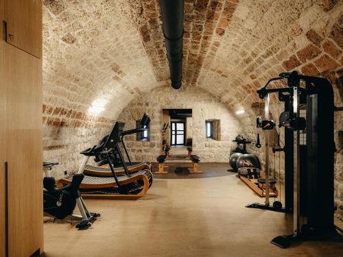 a gym with exercise equipment in a brick wall at Mamula Island in Žanjica
