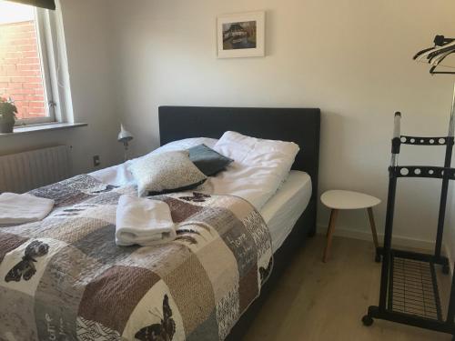 a bedroom with a bed with towels on it at Søhusets anneks1 in Viborg