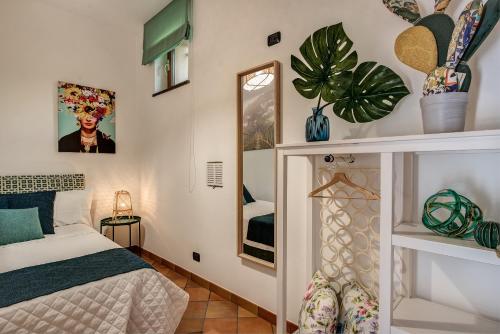 a bedroom with a bed and a mirror at Villa Islamorada Pool and Sea View in Massa Lubrense