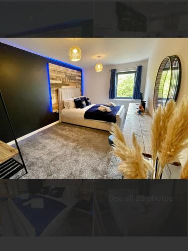 a bedroom with a king sized bed with blue lighting at No 4 Hawthorn View Ground floor apartment in York