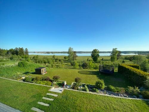an aerial view of a garden with a view of the water at Guestly Homes - 4BR Serene Villa with Garden in Nyköping
