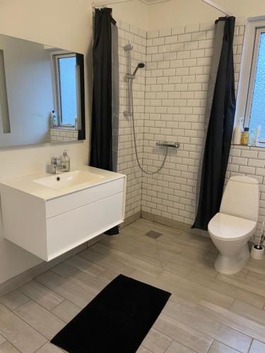 a bathroom with a white sink and a toilet at Søhusets anneks2 in Viborg
