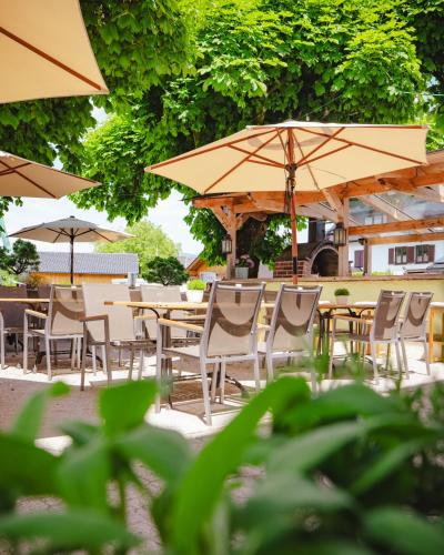 a group of tables and chairs with umbrellas at Hotel Kaiserhof in Anif