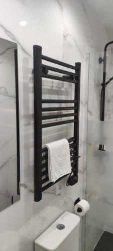 a white bathroom with a sink and a mirror at Apartamento Centro B in San Sebastián de los Reyes