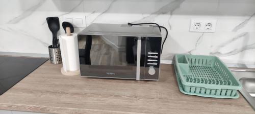 a toaster oven sitting on a counter next to a sink at Apartamento Centro B in San Sebastián de los Reyes
