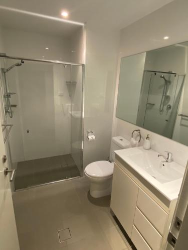 a bathroom with a shower and a toilet and a sink at Molly's on Mount View - Walk to 3 Cellar Doors in Cessnock