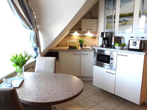 a kitchen with a table and a counter top at Appartement im Haus Deichgraf in Dahme