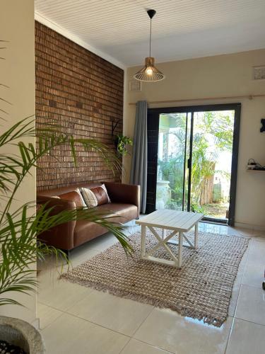 a living room with a couch and a table at Ocean Village in Amanzimtoti