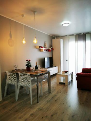 a living room with a table and chairs and a kitchen at Apartment Ruby in Lloret de Mar