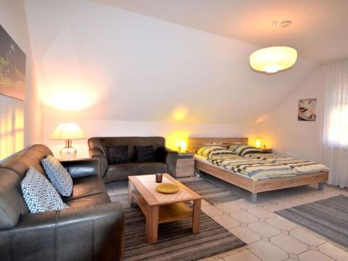 a living room with a couch and a bed at Holiday apartment Kettler in Sassenberg