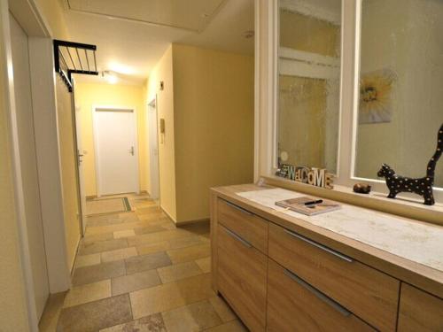 a bathroom with a counter and a window and a hallway at Holiday apartment Kettler in Sassenberg