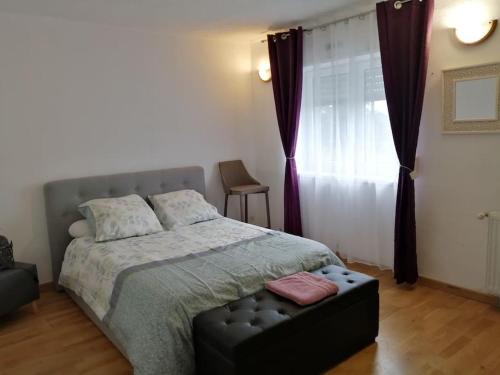 a bedroom with a large bed and a window at Médina maison 4 chambres 100m2 in Beuvrages