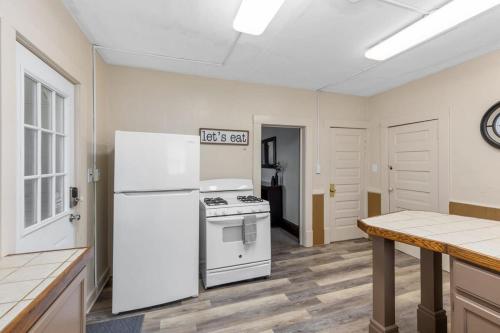 a kitchen with a white refrigerator and a stove at Charming 4BR Westside Home in Beer City USA in Grand Rapids